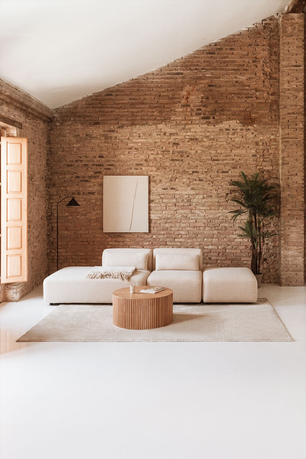 Divano componibile in 2 pezzi con chaise longue sinistra e pouf Fogler
