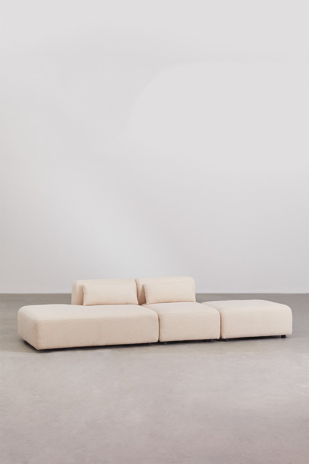 Divano componibile in 2 pezzi con chaise longue sinistra e pouf Fogler